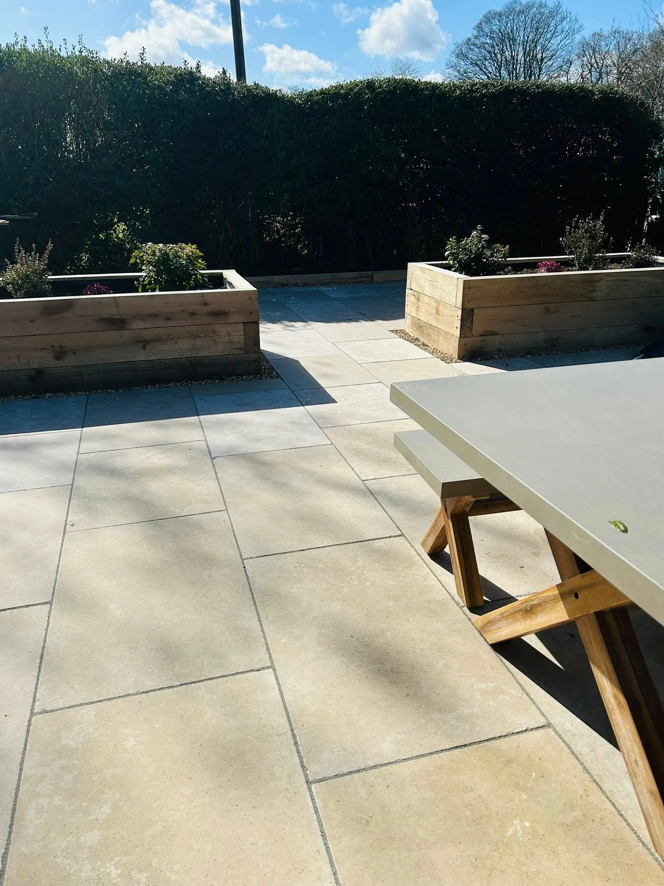 Natural limestone patio seating area installed in Marlow by PMK Surfaces